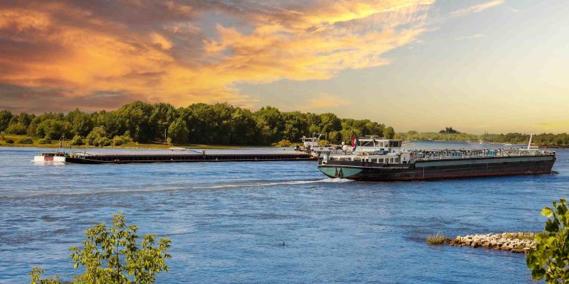 Cargo,Barge,Sailing,On,The,Rhine,River,At,Sunset,,Symbolizing
